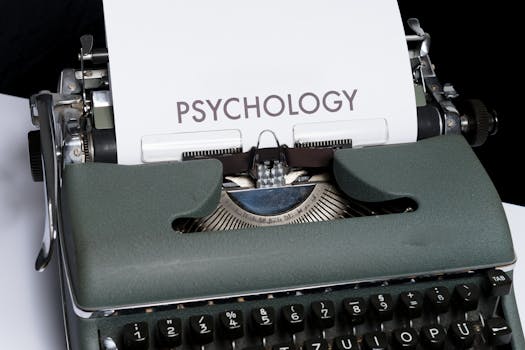 Close-up of an antique typewriter printing the word 'psychology', symbolizing retro communication.