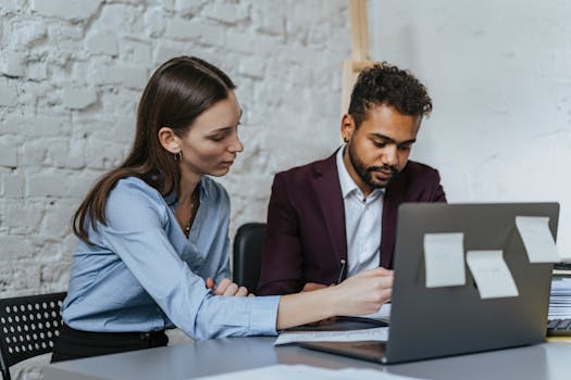 Focused business professionals collaborating in a modern office environment.