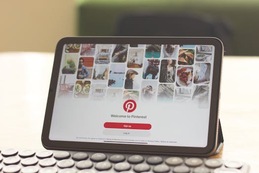 A tablet on a wooden desk showcasing the Pinterest login screen, emphasizing digital connectivity.