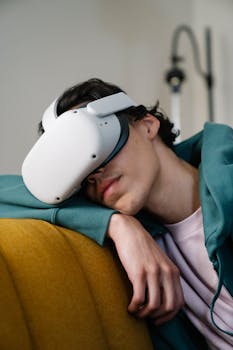 A young adult wearing a VR headset, relaxing indoors. Augmented and virtual reality theme.